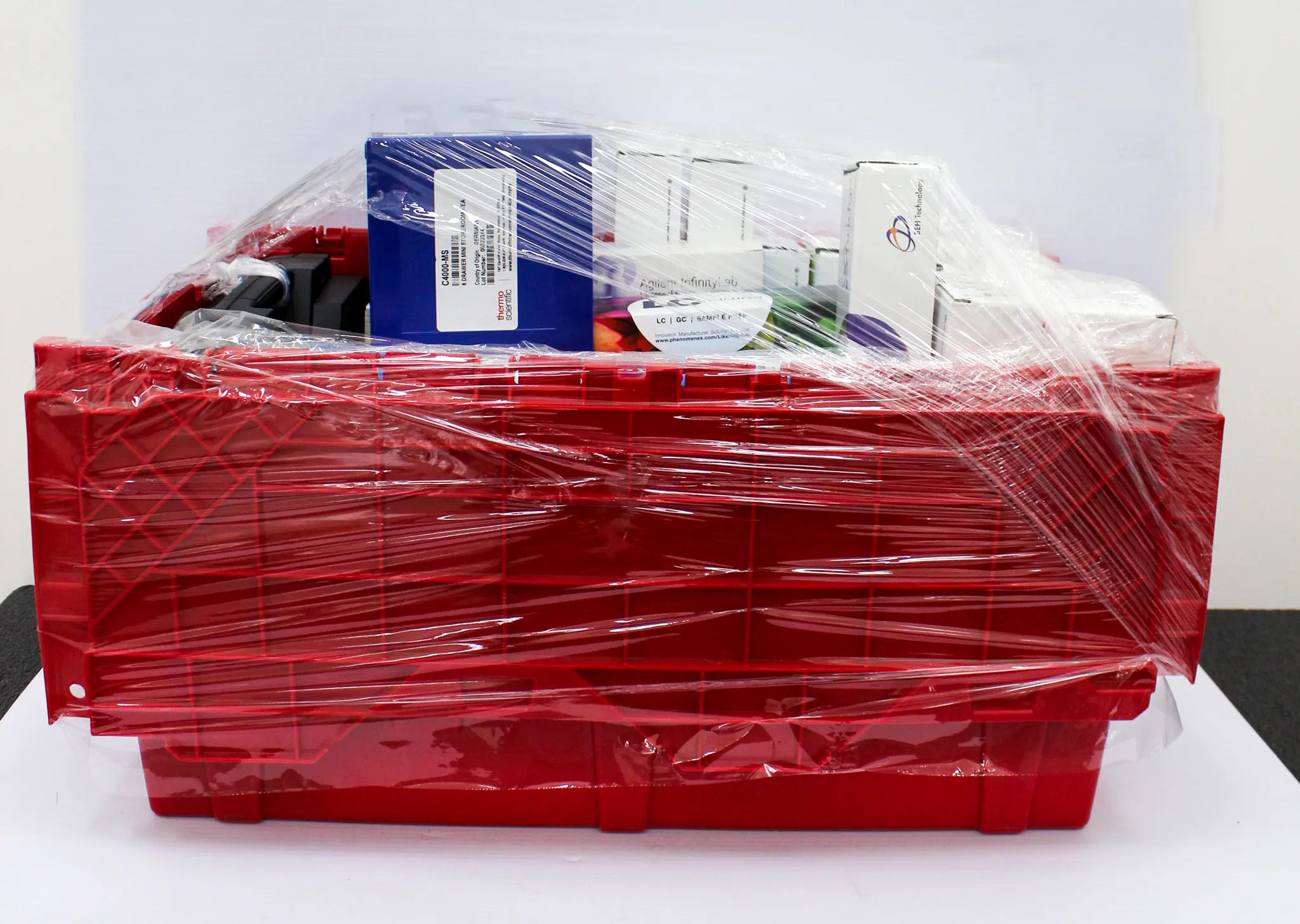 Thermo Scientific Miscellaneous Red Bin with Agilent Accessories, Macroman Pipette Controller, and LC-Tools Box